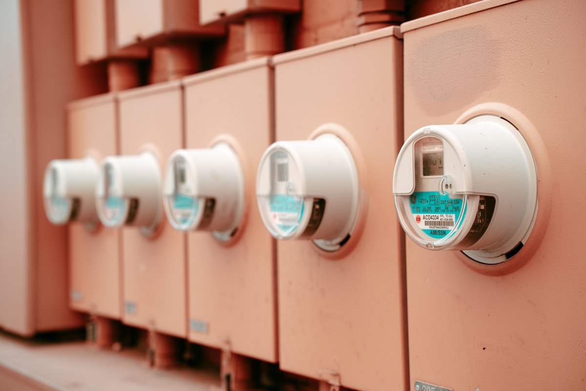 Row of electricity meters mounted on an exterior wall