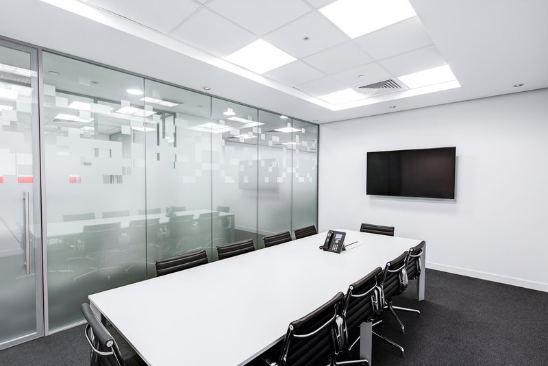Office room with desks and chairs on a smooth gray floor