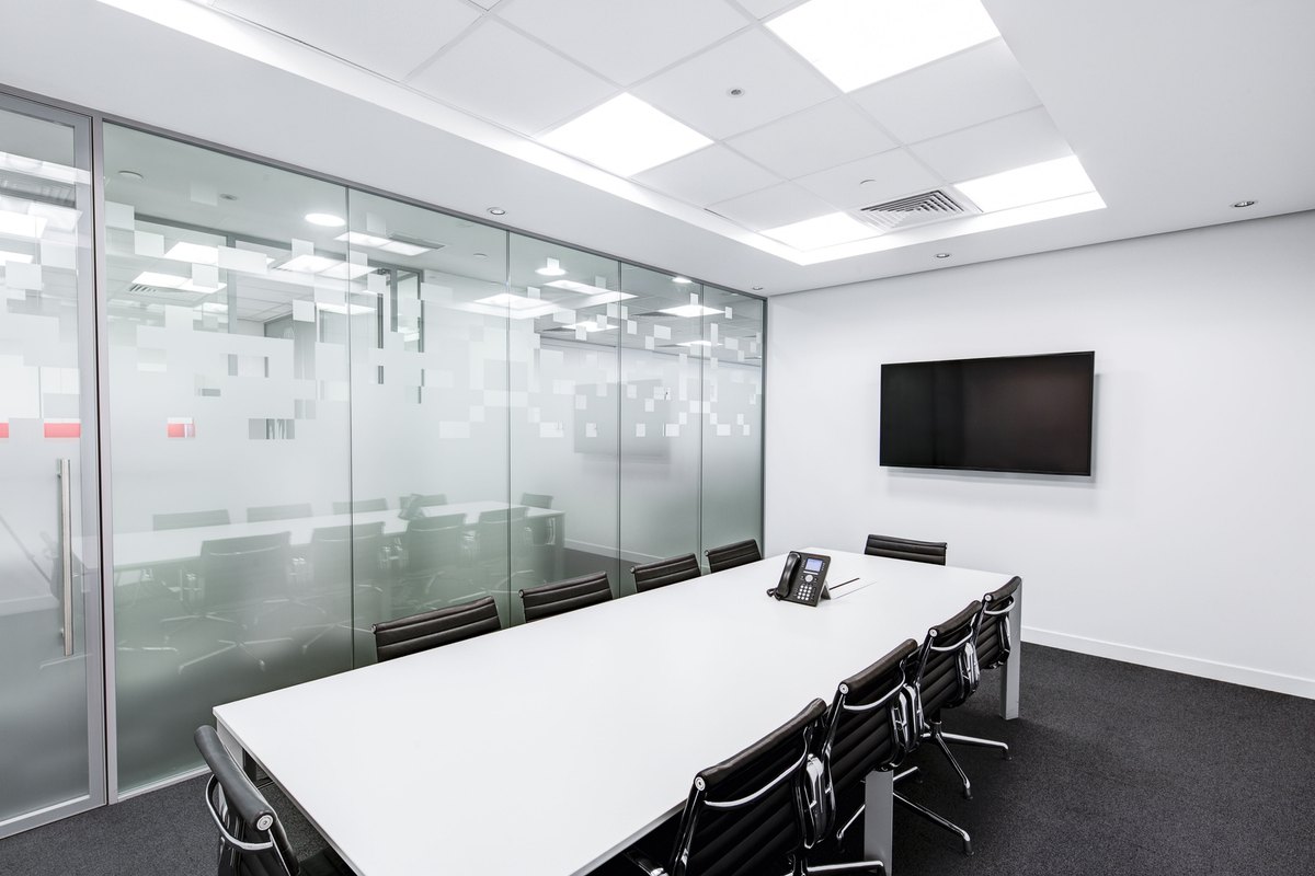 Office room with desks and chairs on a smooth gray floor