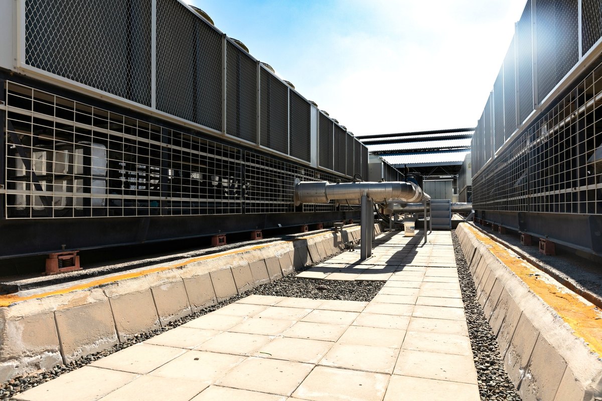 Rooftop air conditioning condenser units along a flat roof