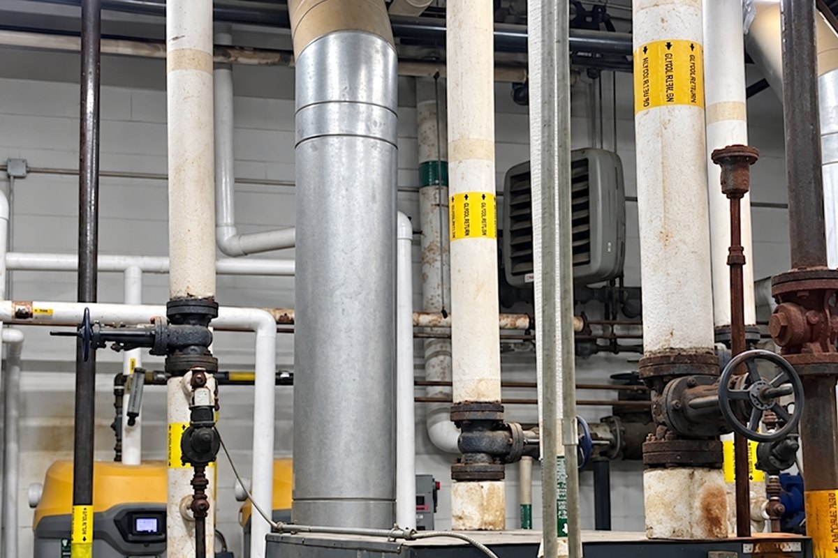 Insulated glycol piping beside a commercial boiler and gas water heater